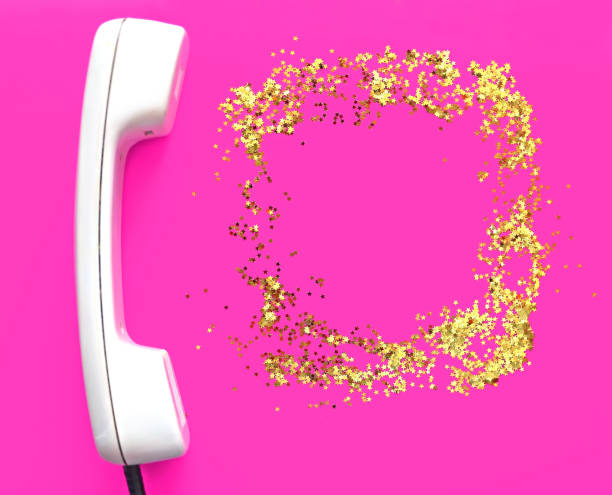 White old handset on fuchsia background. Place for text. Glitter golden stars as a frame. Holiday concept. New Year and Christmas holiday