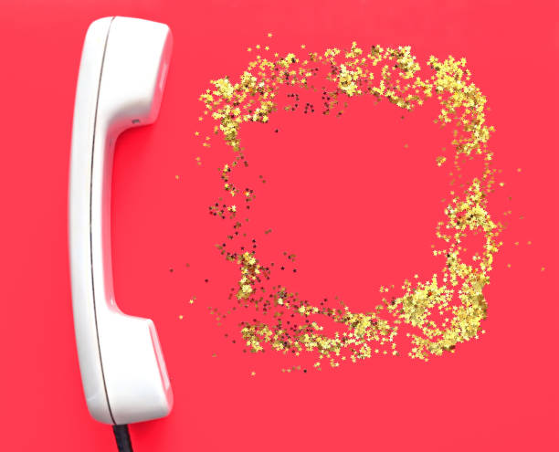 istock White old handset on red background. Place for text. Glitter golden stars as a frame. Holiday concept. New Year and Christmas holiday 1180995292