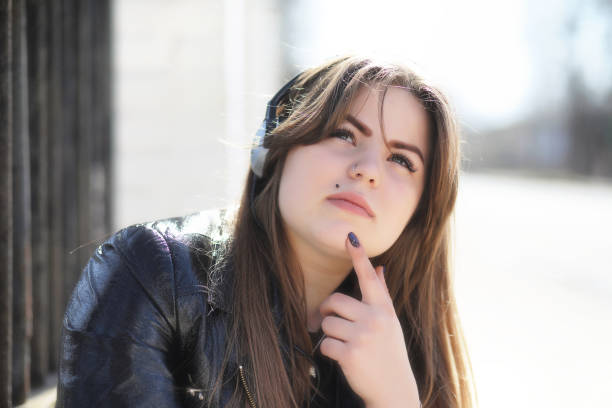istock Cute girl in an autumn park 1180996249