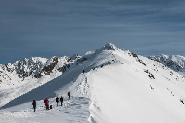 istock Winter view from Kasprowy Wierch Peak on ski slope and Swinca Peak. 1180996654