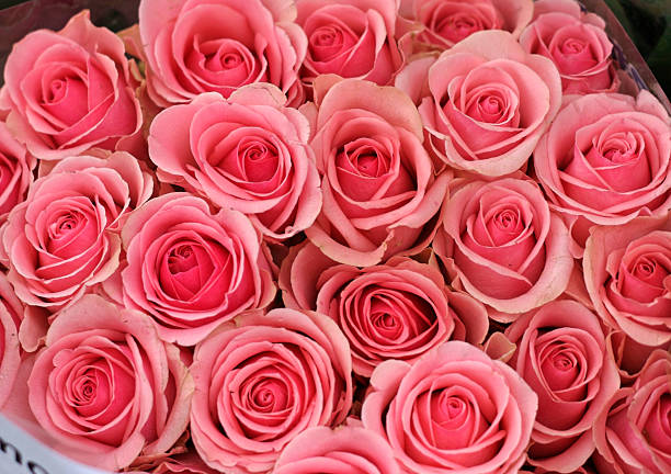 Roses and lisianthus flowers in a bouquet.
