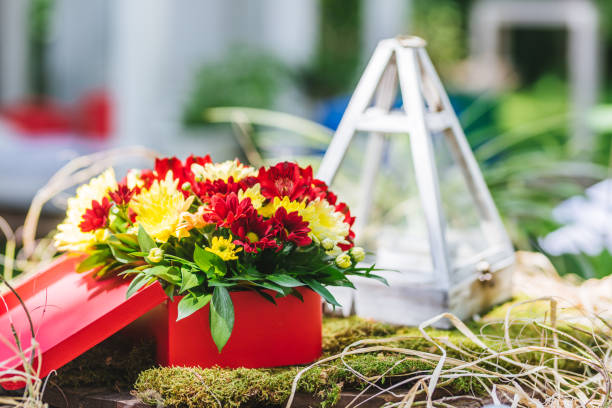 istock Red and yellow fresh flower decoration for a rustic wedding 1180997032