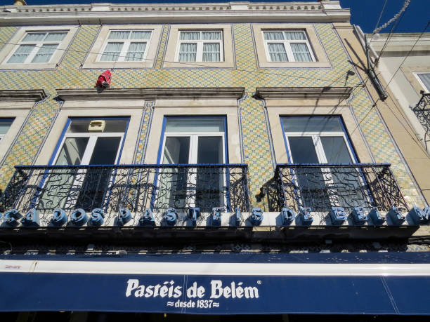 view of  the  typical facade of the building with tiles (azuleios)  wall  of the famous pastry shop "pasteis de belem" of lisbon - pastel de nata ilustrações imagens e fotografias de stock