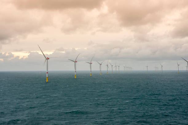 istock Sunset over offshore wind farm - green power generation 1181001129