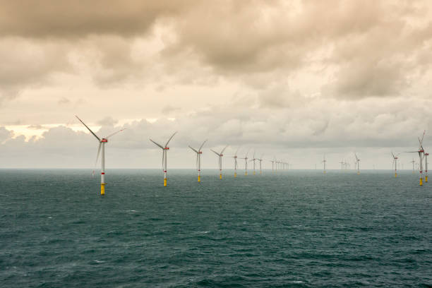 istock Sunset over offshore wind farm - green power generation 1181001192