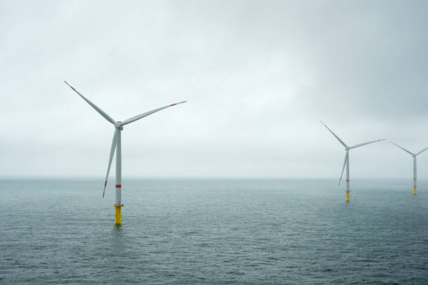 istock Sunset over offshore wind farm - green power generation 1181001397