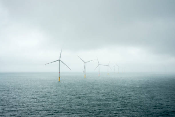 istock Sunset over offshore wind farm - green power generation 1181001473