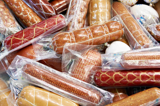 Sausages in plastic vacuum pack Pile of sausages in plastic vacuum packs vacuum packed stock pictures, royalty-free photos & images