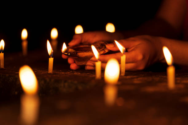 istock Female Hand Illuminating Candles 1181004287
