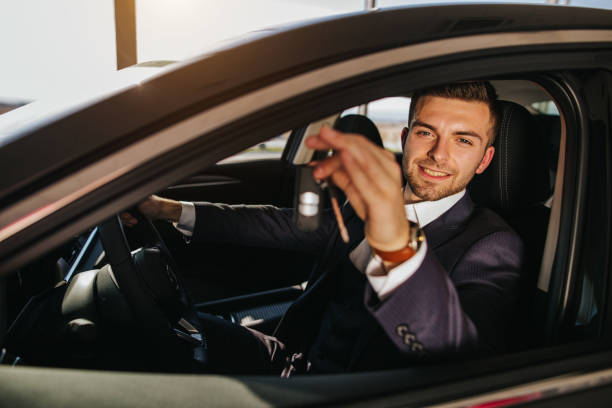 istock Successful well dressed young man holding new car keys 1181004344