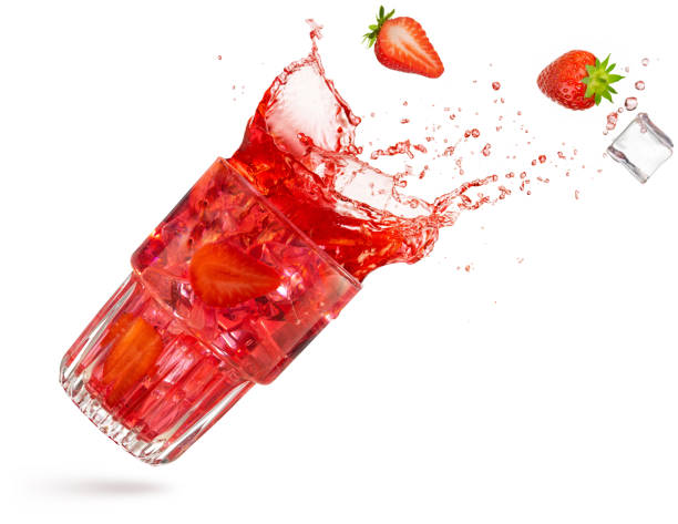 red fruit cocktail splashing isolated on white bacground stock photo