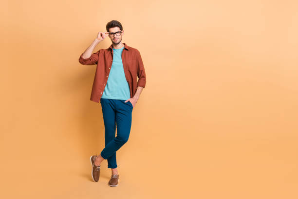 istock Full length body size view of his he nice attractive content brunette guy expert executive manager touching specs posing isolated over beige color pastel background 1181006535