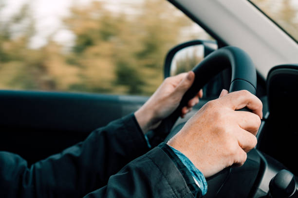 istock Female hands on steering wheel 1181006601