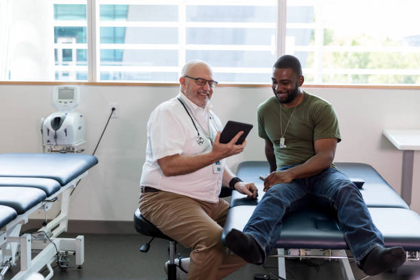 istock Therapist smiles as he shows veteran his improvement on tablet 1181008005