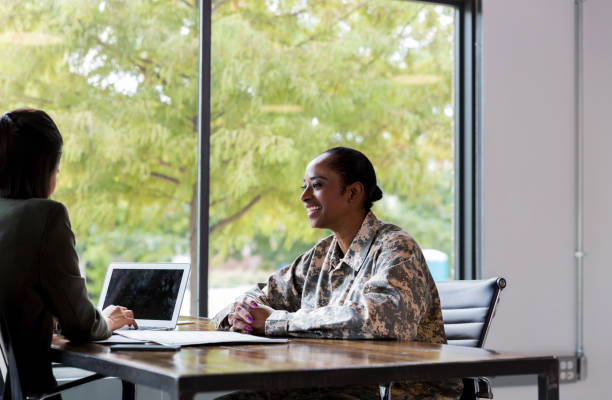 istock Smiling female veteran talks with financial advisor 1181008213