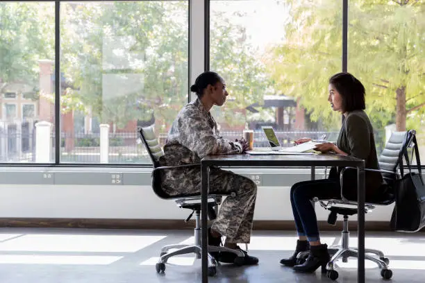 Photo of Bank officer meets withe female soldier