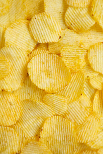 istock Salted wavy potato chips, top view. Overhead, from above, flat lay. Close-up. 1181008262