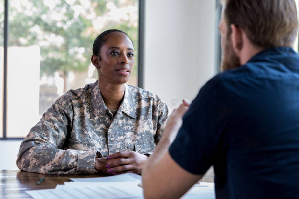 istock Female veteran talks with loan officer 1181008306