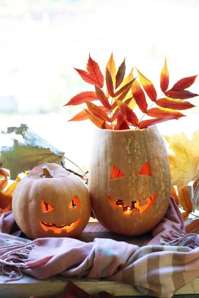 istock Halloween composition from jack-o-lanterns, a warm scarf, pumpkins, illuminations 1181009175