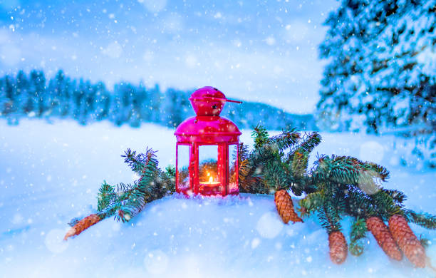 istock Christmas lantern with fir branches on snow 1181009559