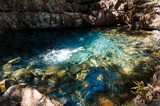 Girl swimming underwater on a natural pool on a river in Chapada dos Veadeiros, Goias, Brazil