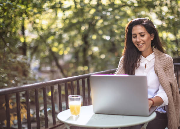 istock Woman working on the terrace on a laptop 1181012062