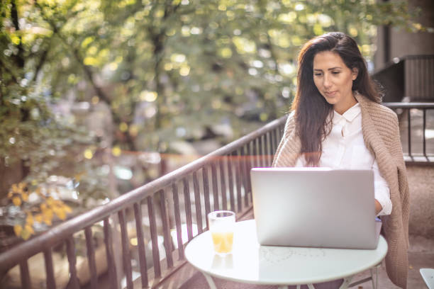 istock Woman working on the terrace on a laptop 1181012093