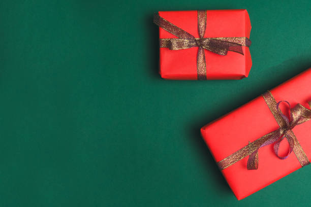 istock Christmas background with present box, holiday decorations on dark green background top view. Holiday banner for website. 1181013374