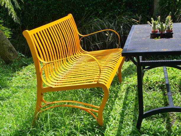 istock Yellow wood bench in garden 1181014661