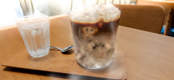 istock Ice coffee and water on the wooden table 1181015995