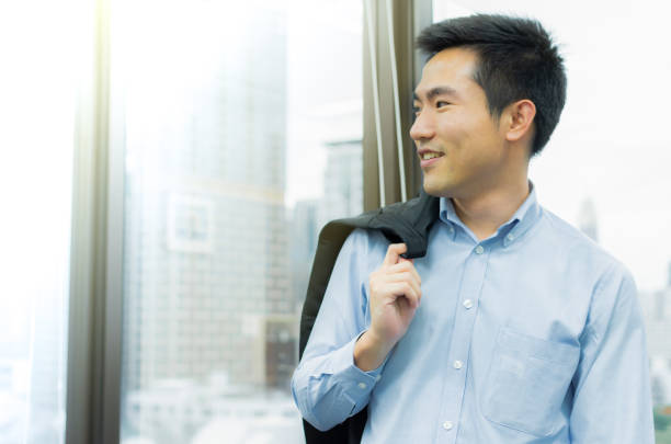 istock Business man is standing beside the window in the office 1181017151