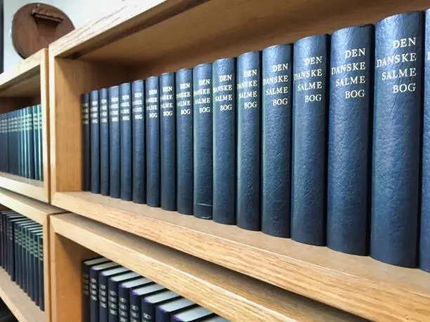 Row of Danish hymnals on a shelf