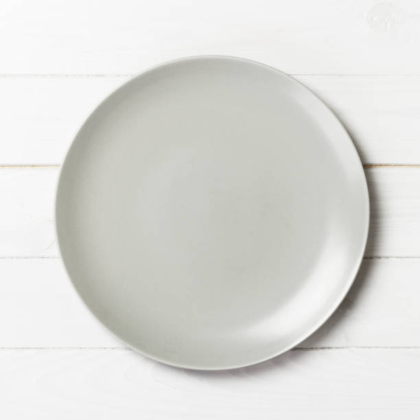 istock Top view with empty for you design. Empty white plate on wooden background 1181018752