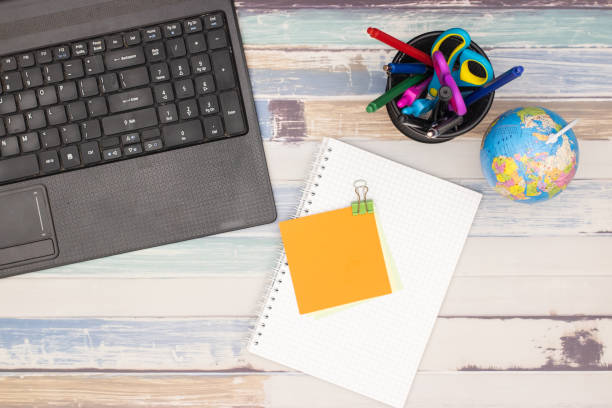 istock Top view of office table. Office supplies on the table 1181020068