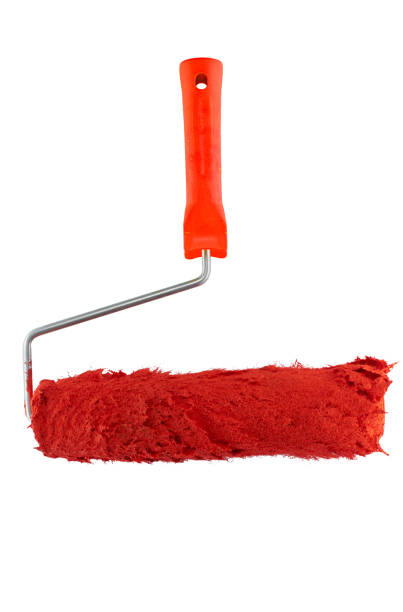 red paint roller with red paint. isolated of white. vertical frame stock photo
