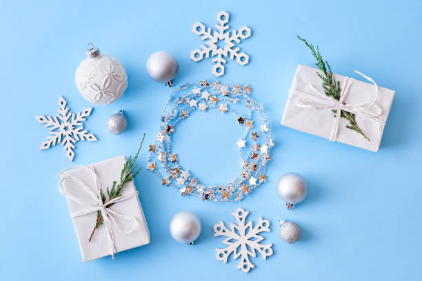 istock Flat lay christmas frame with snowflakes, balls and gift box on a blue background 1181020426
