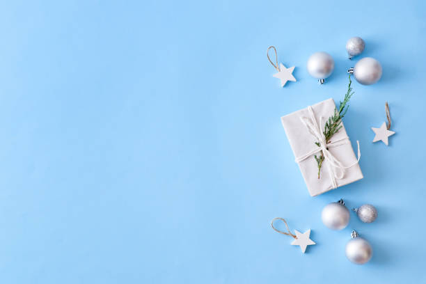 istock Flat lay christmas border with silver christmas balls and gift box on a blue background 1181020448
