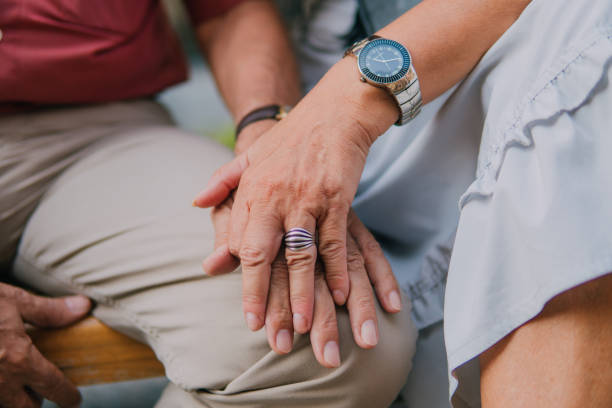 istock Old couple holding and showing their hands 1181022401