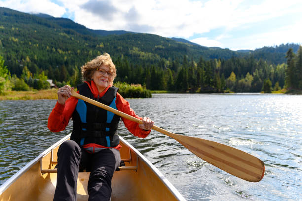 istock Active senior woman canoeing on vacation 1181022529