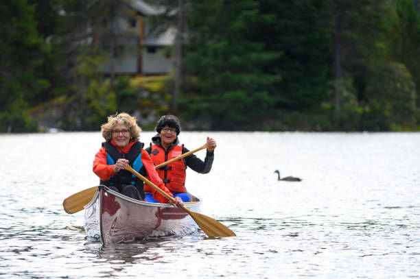 istock Active senior women canoeing on vacation 1181022557