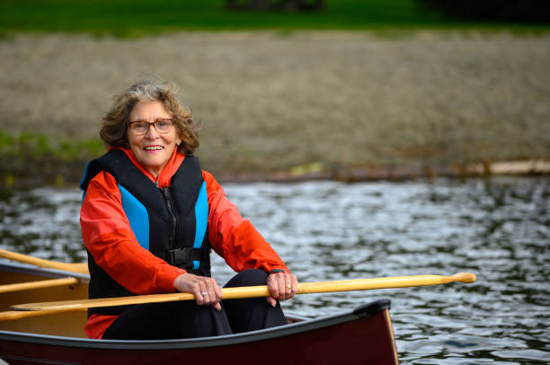 istock Active senior woman canoeing on vacation 1181022564