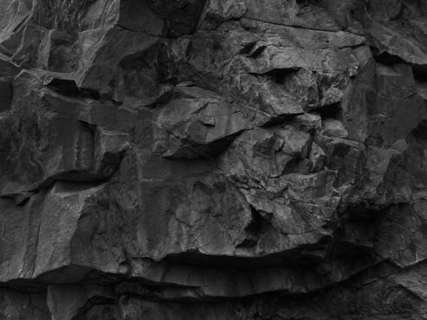 istock Rock texture. Rock formations texture. Dark black grunge stone texture background. Fragment of a mountain close-up. 1181023612