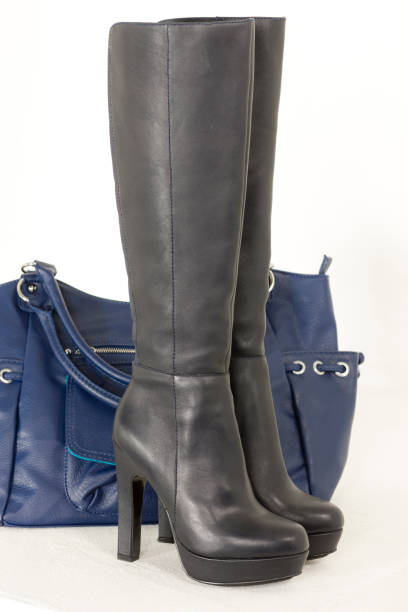 istock fashionable black boots with a handbag 1181023975