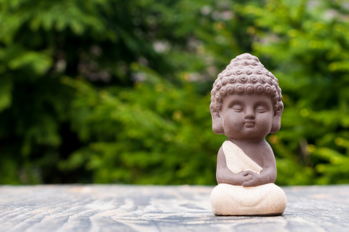 Baby Budda Statue, Teacher or yoga master. Little monk. Meditation and zen, relaxation concept.