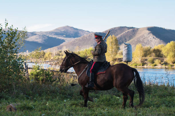 descendants of the Cossacks in the Altai CHARISHSKOE. ALTAISKIY KRAI. WESTERN SIBERIA. RUSSIA - SEPTEMBER 15, 2016: descendants of the Cossacks in the Altai, cossack rides a horse, with a saber at the festival on September 15, 2016 in Altayskiy krai, Siberia, Russia. cossack stock pictures, royalty-free photos & images