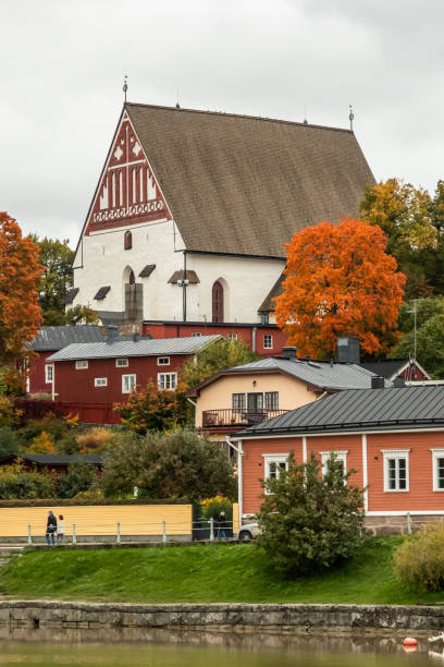 view of old porvoo, finland. beautiful city autumn landscape with porvoo cathedral and colorful wooden buildings. - medieval autumn cathedral vertical imagens e fotografias de stock