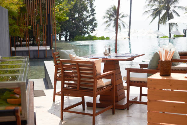 istock dining table on swimming pool near the beach 1181029543