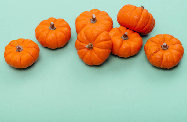 istock Pumpkins over neo mint background. 1181030699
