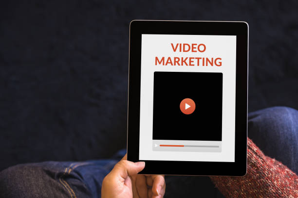 istock Hands holding tablet with video marketing concept on screen 1181031619