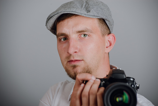 Young man using a professional camera in studio